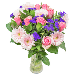 As I compose this arrangement from our Yeading shop, I am captivated by the interplay of blush-toned gerberas and classic pink roses-colours that recall the gentle sunrises over Yeading Lane. Watercolour-soft hues mingle through the bouquet, with rich purple statice adding playful highlights, creating a sense of movement which echoes the liveliness of the local community. Fresh, dewy foliage grounds the arrangement, lending an earthy coolness and the scent of spring mornings akin to walks near Yeading Brook. The entire composition is housed in an understated glass vase, its transparency expanding the luminous feeling of the bouquet, inviting a closer, appreciative glance. Whether gifted as a get-well gesture or styled as a cheerful addition in a Yeading living room, this bouquet embodies expert craftsmanship and attentiveness, delivering brightness and optimism in every detail for the people of Yeading.